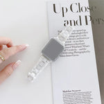 Ceramics replacement strap for Apple Watch displayed on a magazine, showcasing a stylish rhombic grid design.
